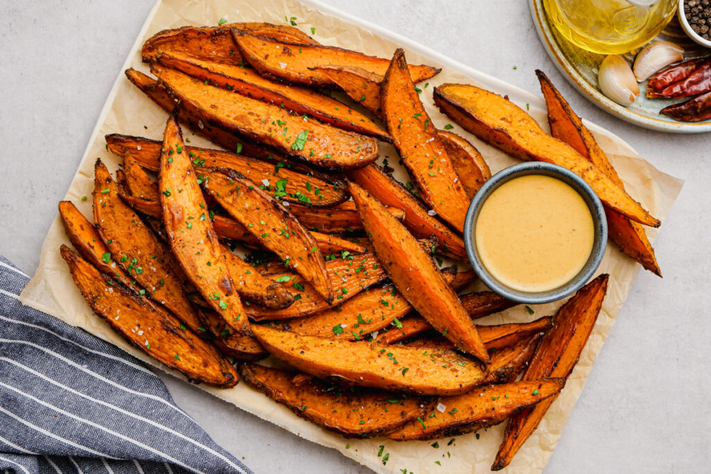 Sweet Potato Wedges on a tray with dipping sauces. 