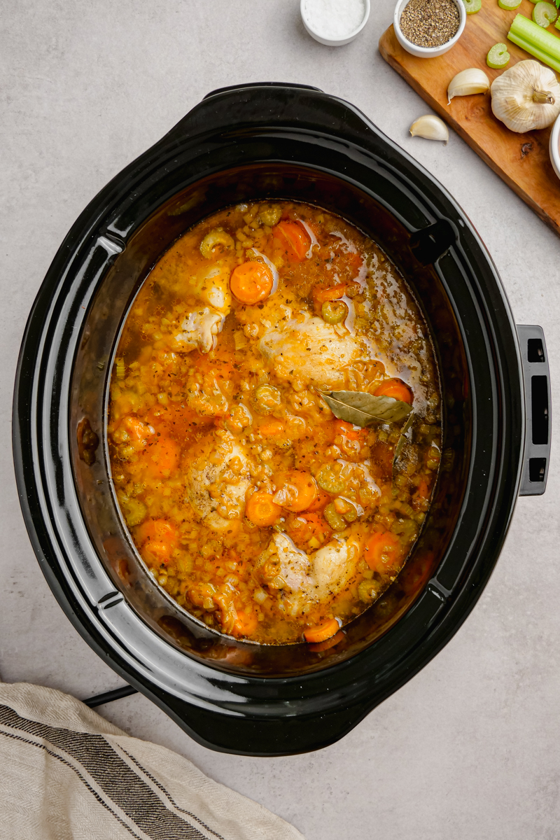 A slow cooker with broth