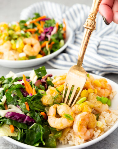 Caribbean shrimp on a plate with coconut rice and chard salad