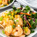 A plate with Caribbean shrimp and coconut rice and a chard salad