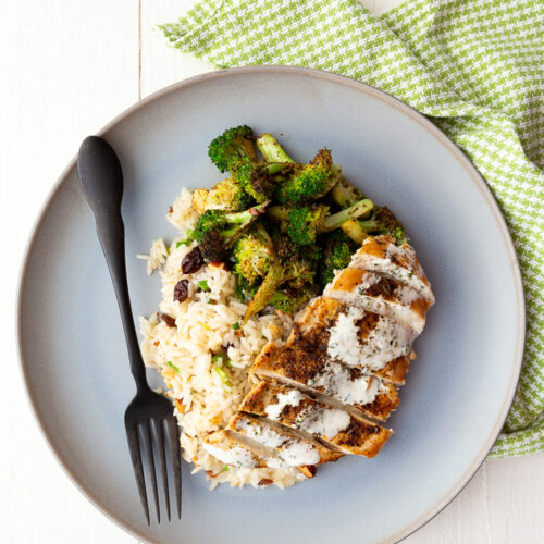 Chicken with Lemon Crema on a blue plate with a green napkin