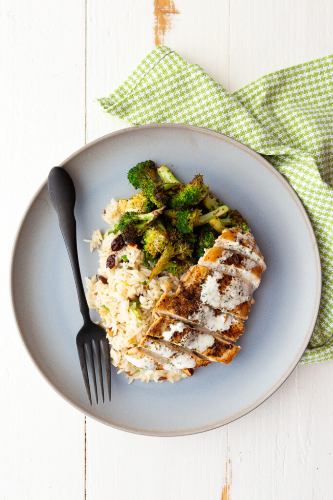 Chicken with Lemon Crema on a blue plate with a green napkin