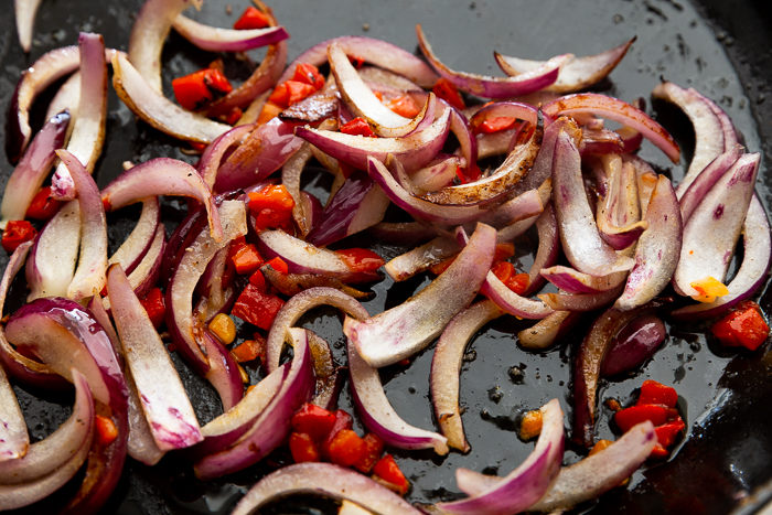 Cooking peppers and onions