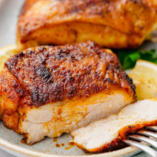 Tender juicy chicken thighs that were roasted in the oven after being coated with spices.