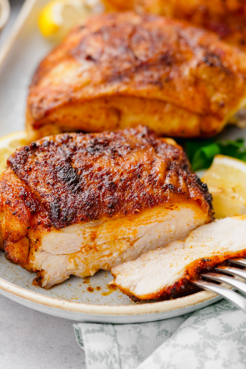 Tender juicy chicken thighs that were roasted in the oven after being coated with spices.