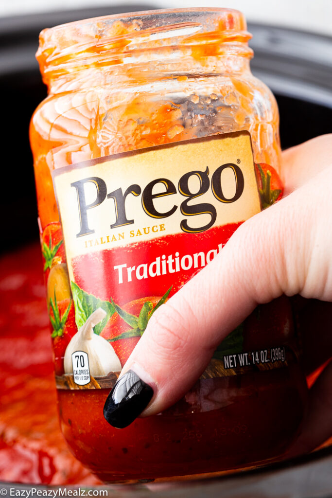 Adding more Prego sauce to the slow cooker