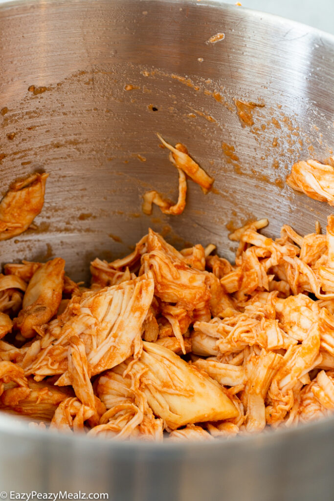 Shredded chicken in a kitchenaid bowl