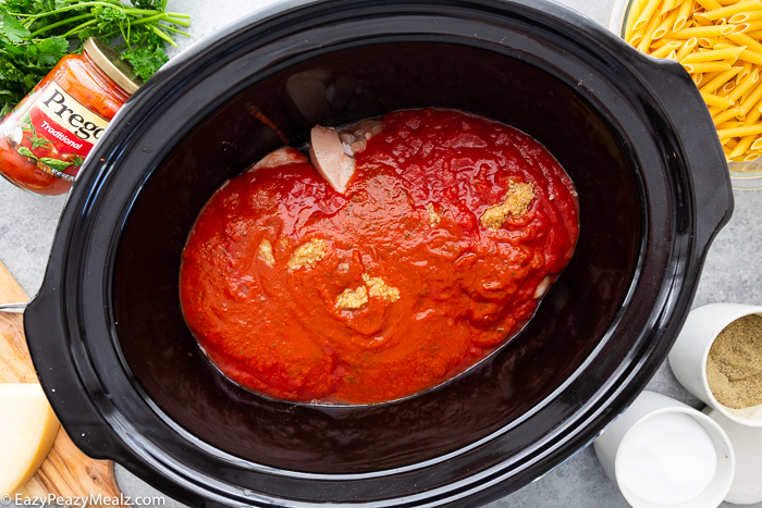 Slow Cooker Chicken Parmesan Casserole being made in a slow cooker