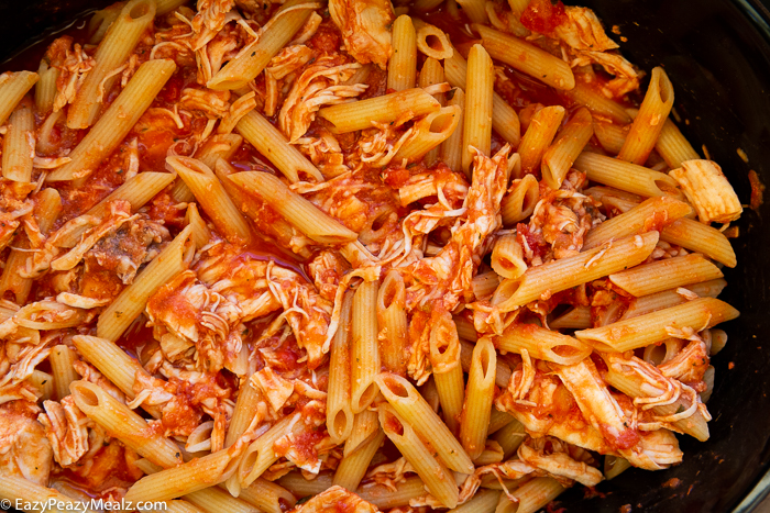 Penne with sauce, chicken and cheese in a slow cooker. 