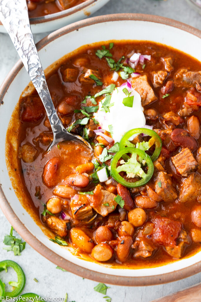 Brisket chili in a bowl with toppings