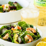 A bowl of spring salad with citrus shrimp