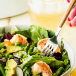 Citrus Shrimp Spring salad with a fork iced tea in background