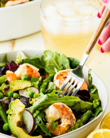 Citrus Shrimp Spring salad with a fork iced tea in background