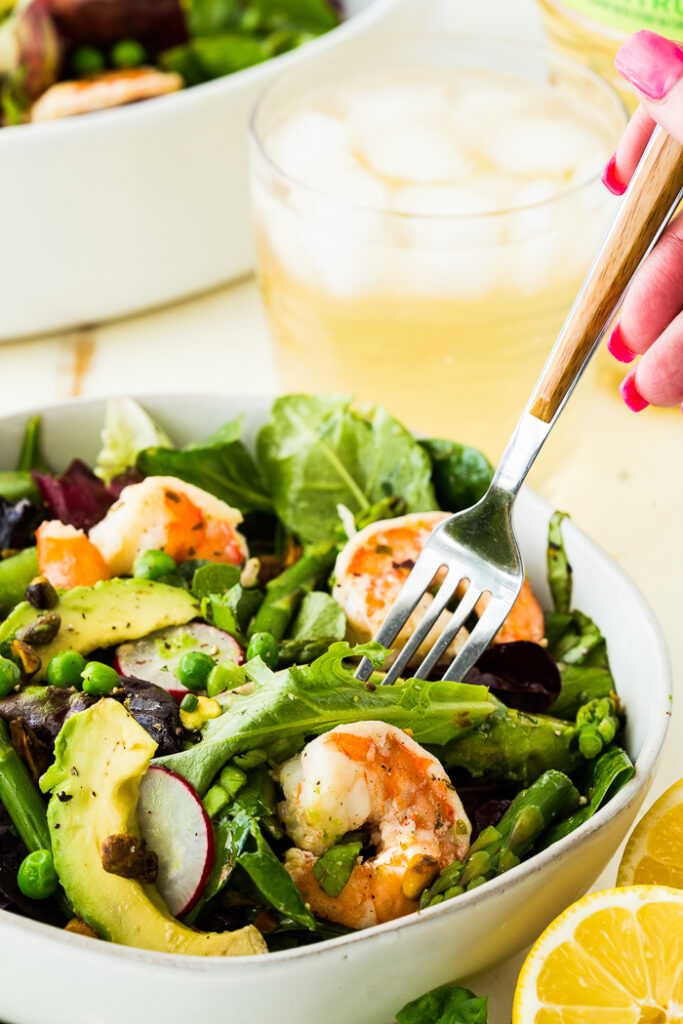 Citrus Shrimp Spring salad with a fork iced tea in background