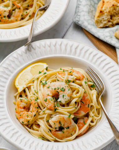 shrimp scampi on white plate with fork