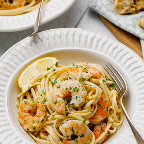 shrimp scampi on white plate with fork