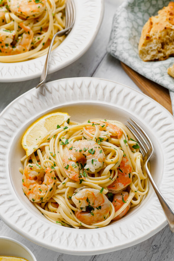 shrimp scampi on white plate with fork