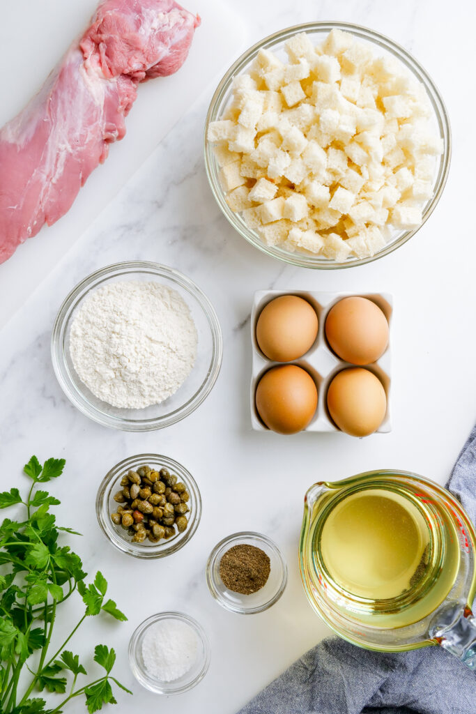 Schnitzel ingredients for making german pork schnitzel, fried tender, thin meat in a crispy golden crust. 