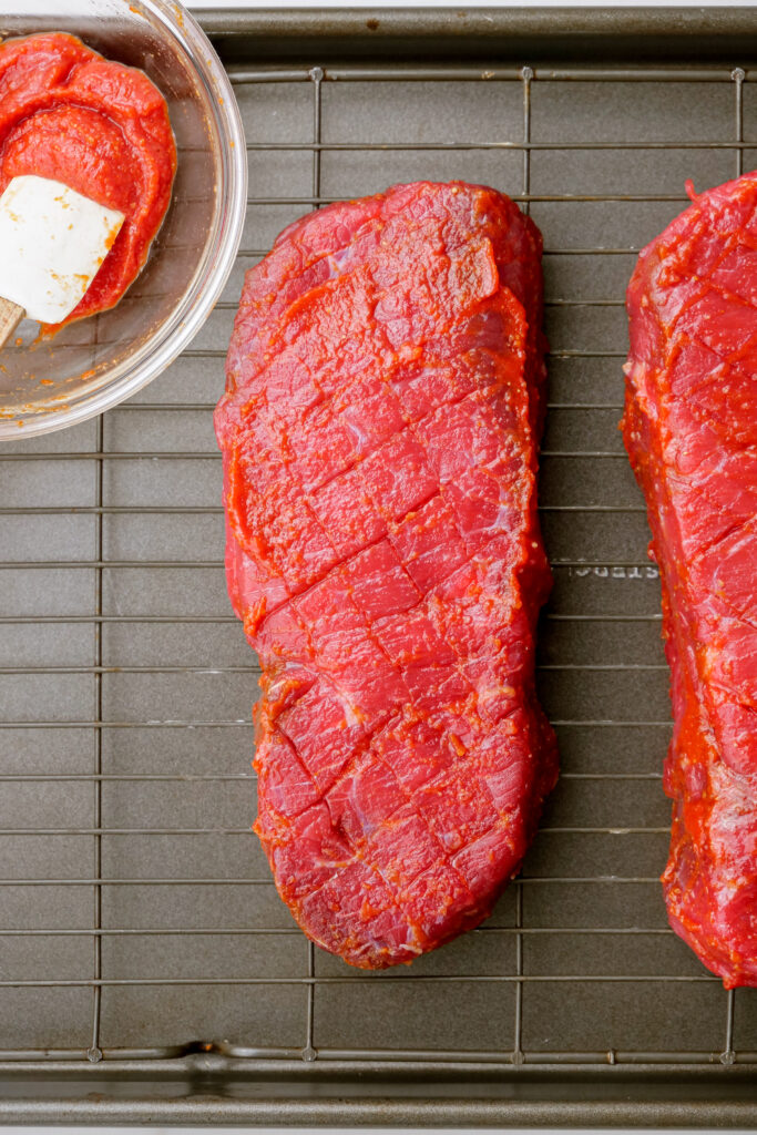 Scoured steaks with a prepared rub on the side. 