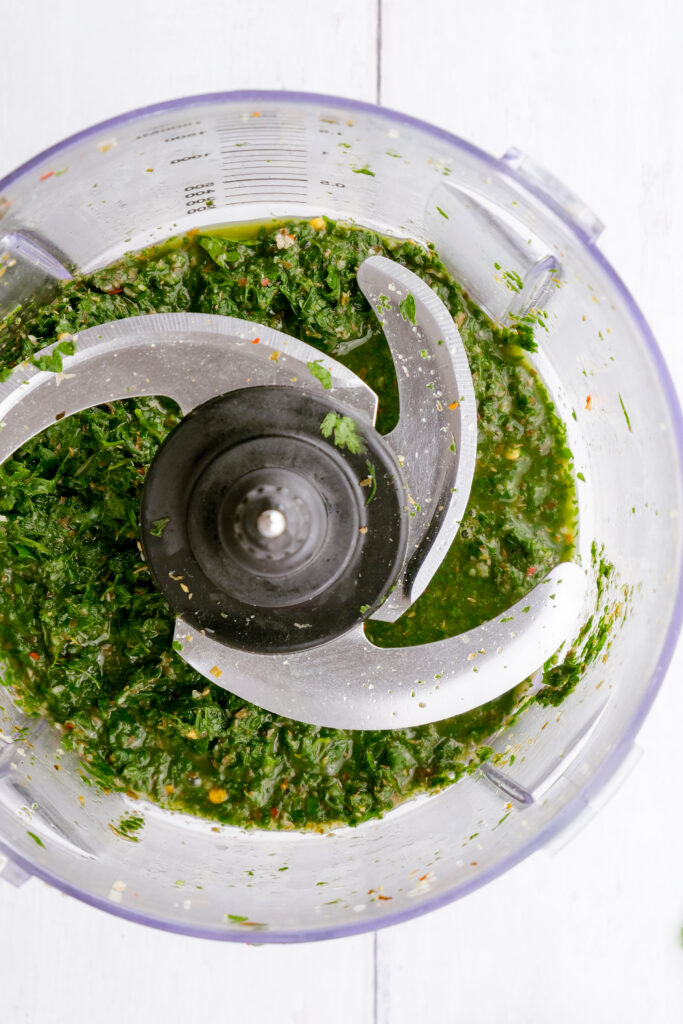 food processing the ingredients for a chimichurri sauce