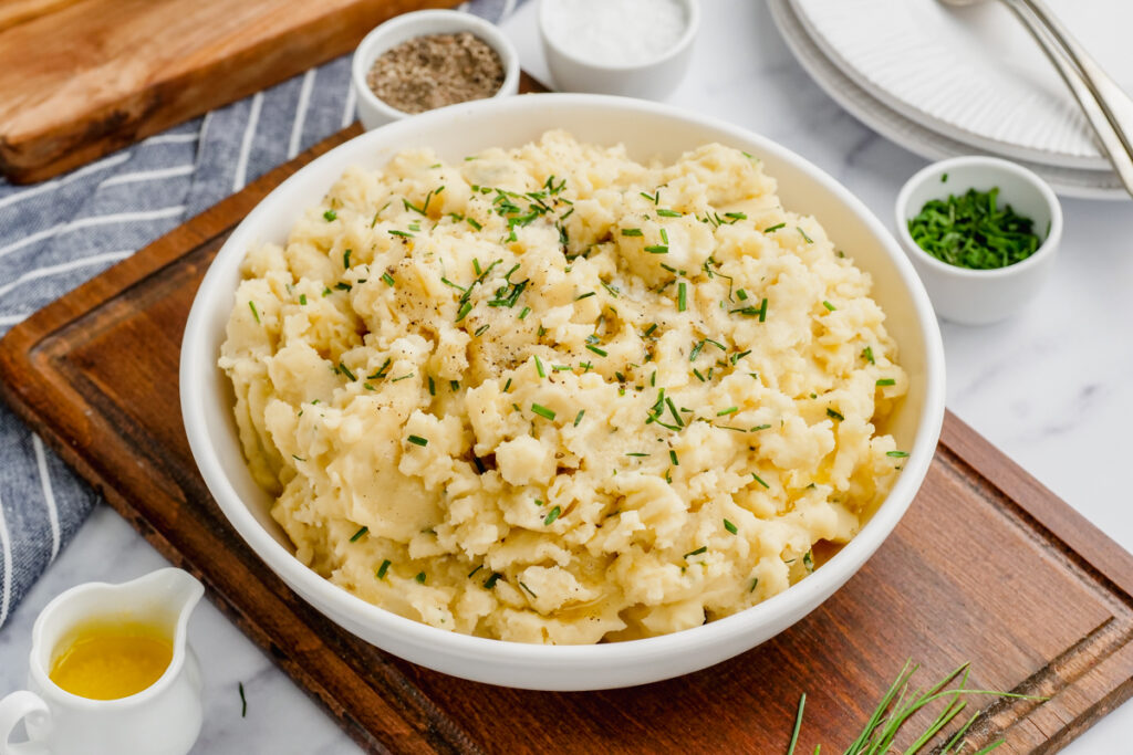 Slow cooker mashed potatoes in a white bowl