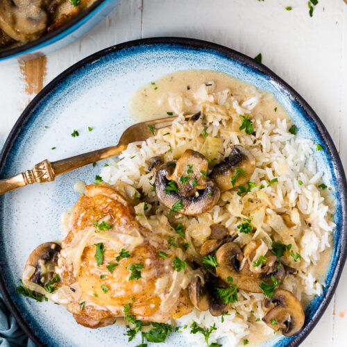 Creamy mushroom chicken on a blue plate