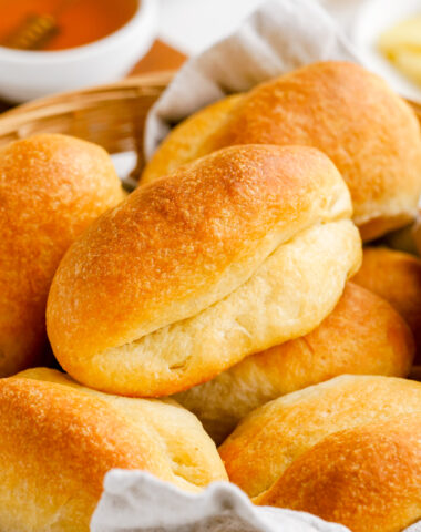 Parker house rolls stacked in a basket.