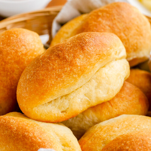 Parker house rolls stacked in a basket.