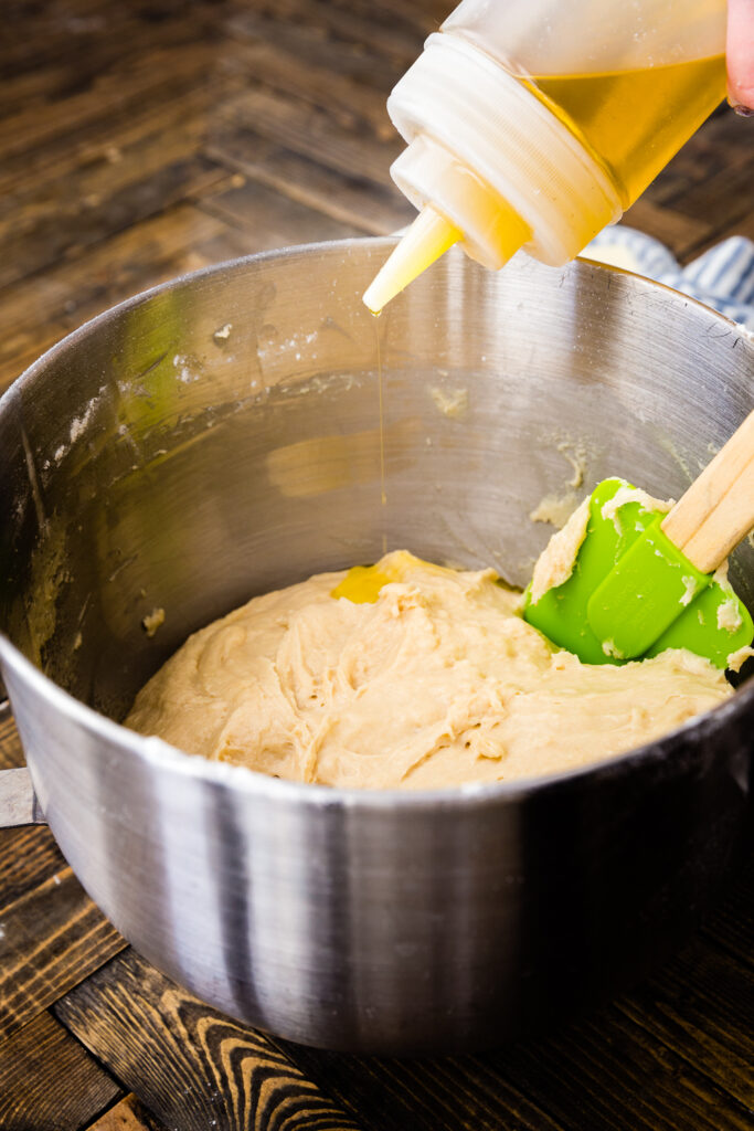 Adding oil to a roll dough to make lion house rolls