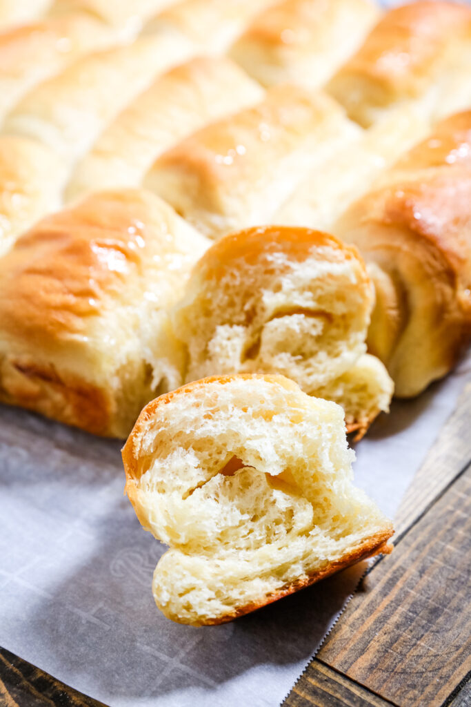 Seriously yummy Lion House rolls, these dinner rolls are on a baking sheet, and golden brown on top