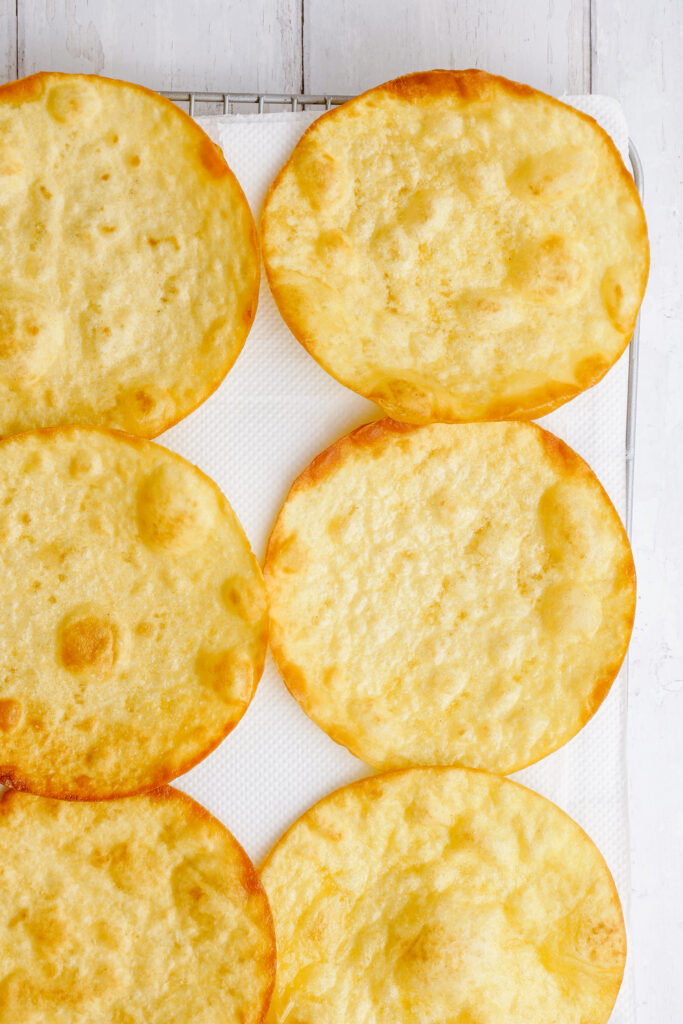 Fried tortillas, being made into pork tinga for tostadas