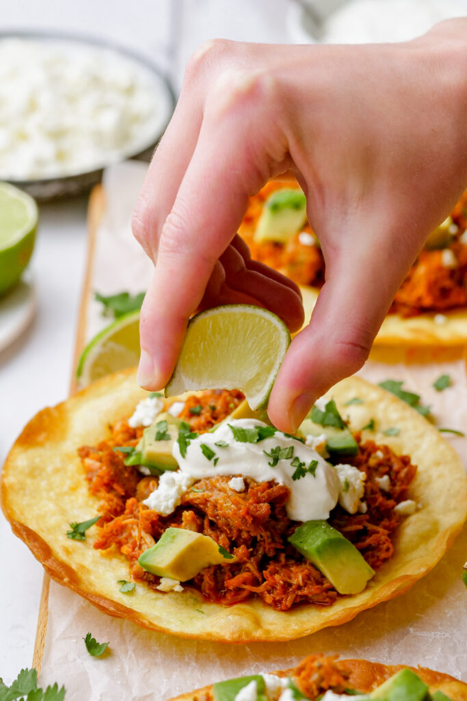 Garnish your tinga tostada with all of the toppings