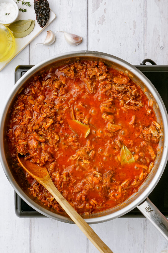 Tinga being prepared with the tomatoes and spices