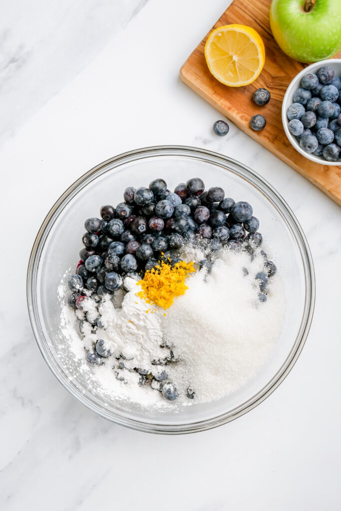 Adding the rest of the ingredients to blueberry pie filling. 