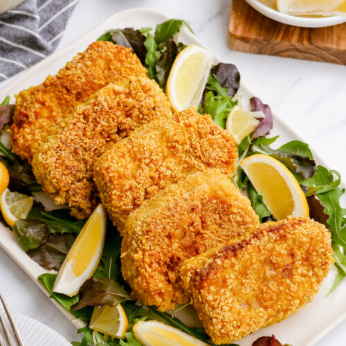 breaded pork chops on a platter