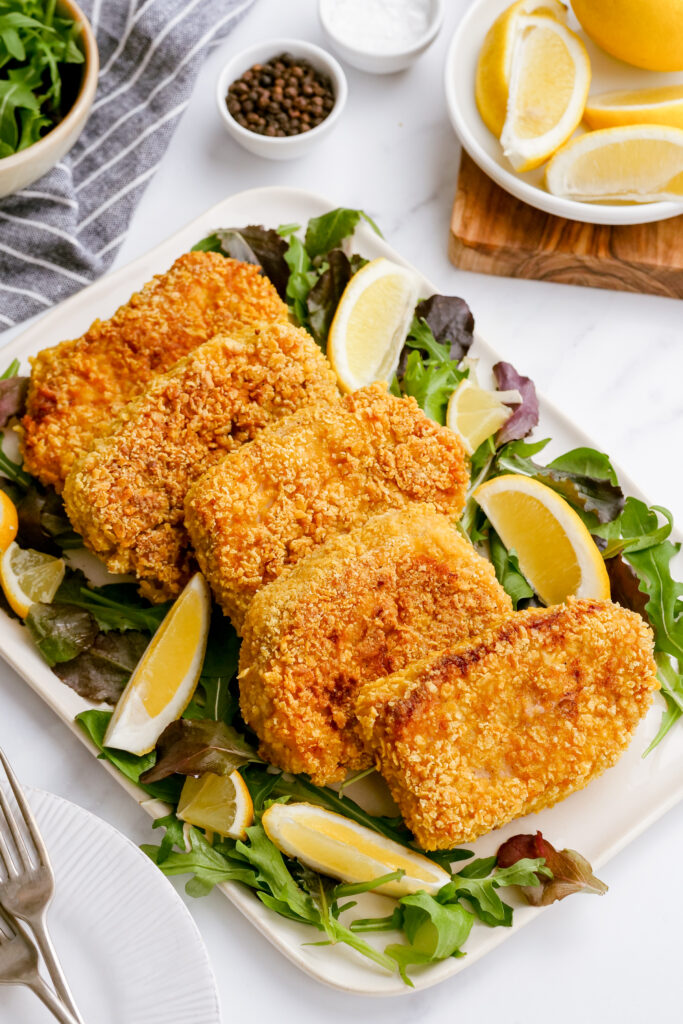 breaded pork chops on a platter