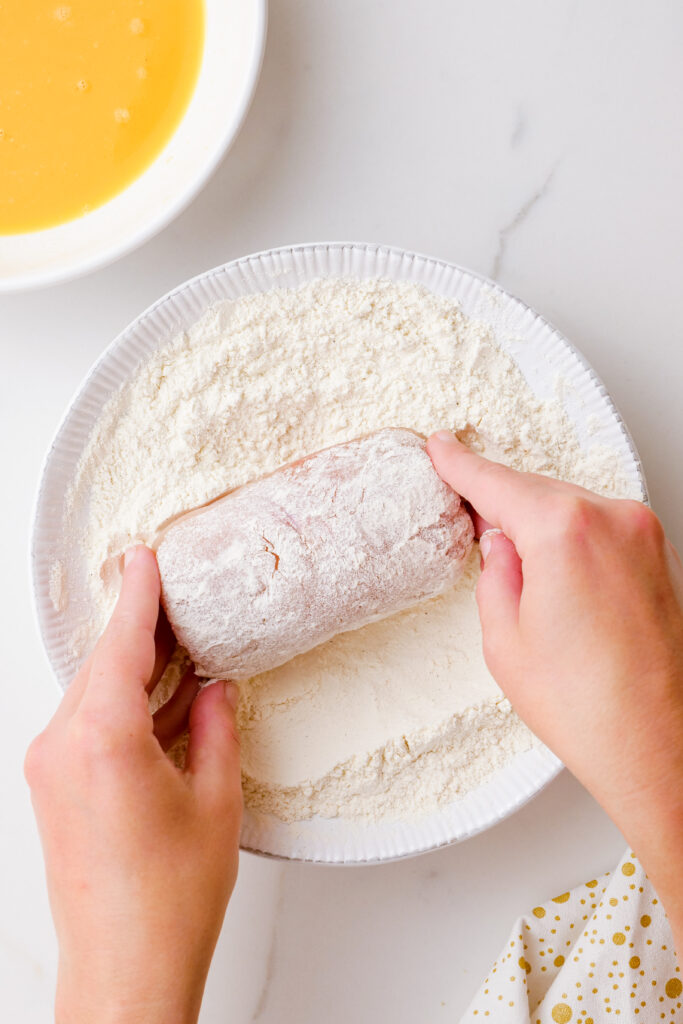 dredging chicken with seasoned flour, eggs, and breadcrumbs