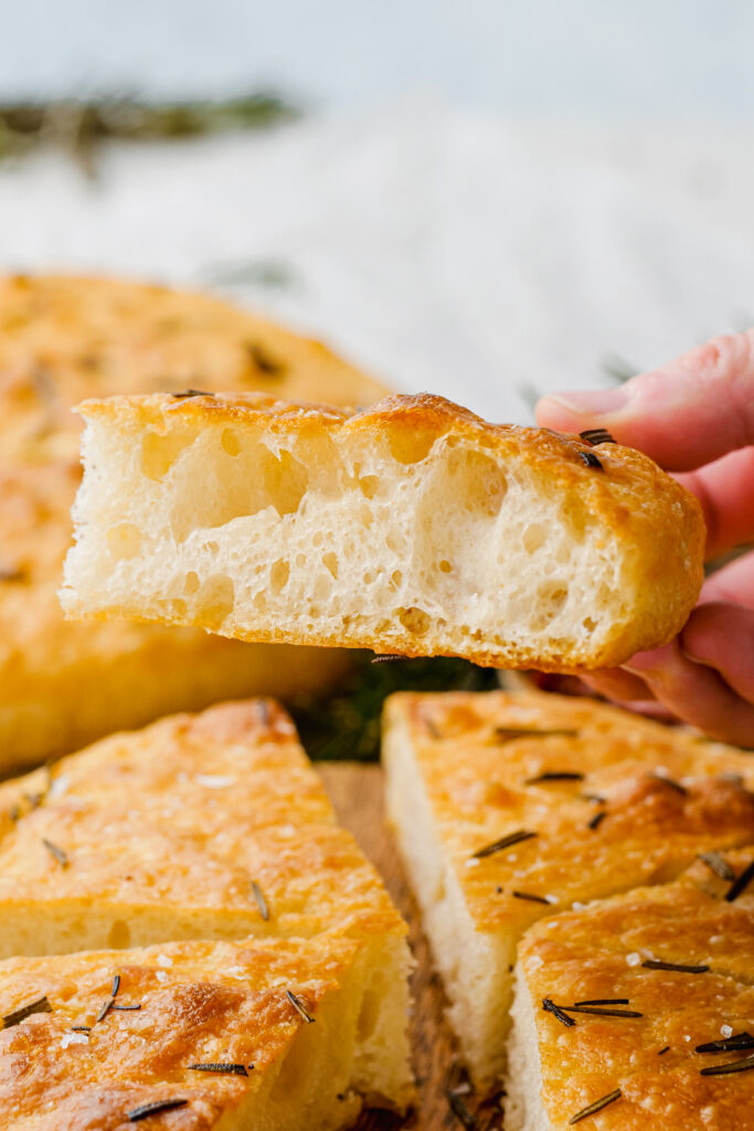 A slice of focaccia with all the lovely air bubbles