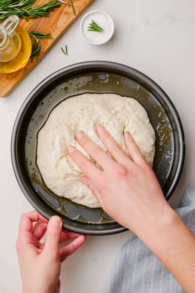 Prepping dough for the pan to cook