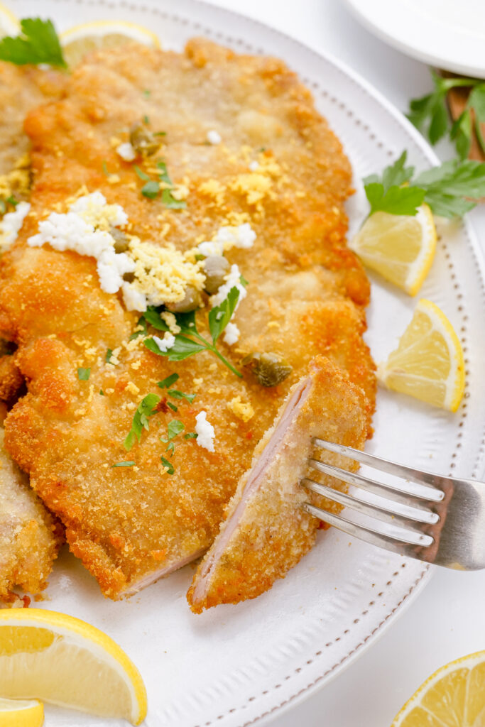 Cutting into pork schnitzel