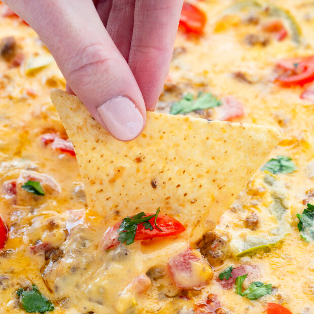 Smoked queso cheese dip, a simple sausage beer cheese dip that you cook on a grill or smoker for ultimate flavor.