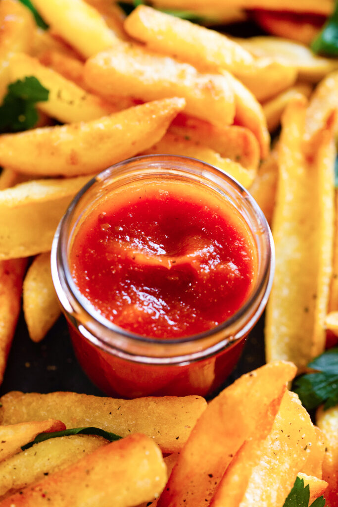 How to make homemade ketchup and a jar of it surrounded by fries