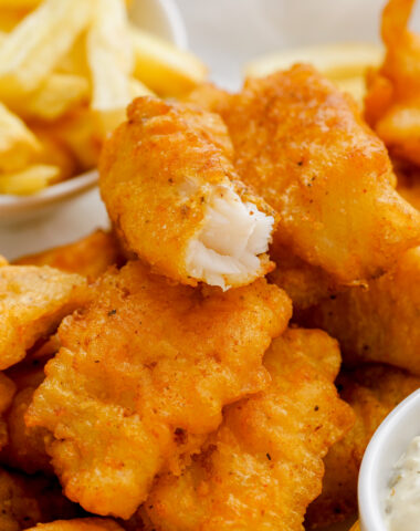 Beer Battered Fish: crispy beer battered fish on a stack of other pieces of fish