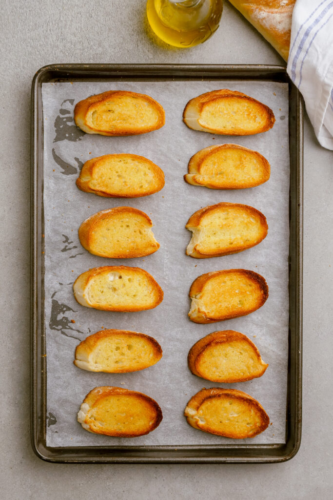 Toasted baguettes to serve as the base for bruschetta