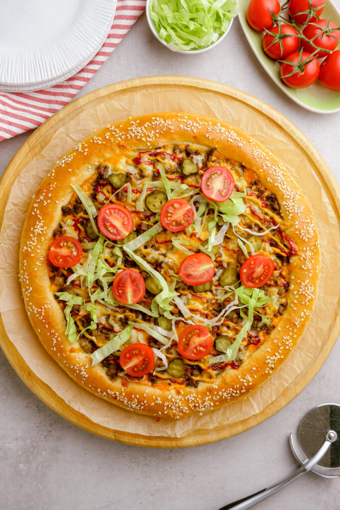 Garnished cheeseburger pizza