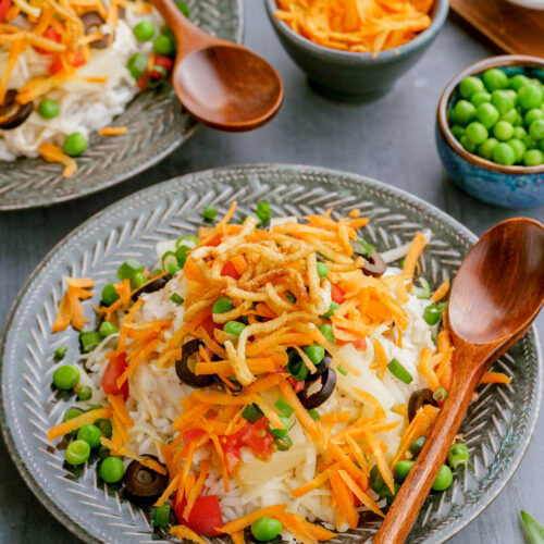 A plate of Hawaiian haystacks. A creamy chicken gravy served over rice with a variety of fun fresh toppings.