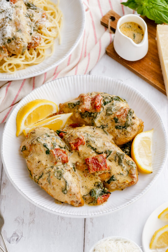 Finished Tuscan Chicken cooked in the pressure cooker and placed on a white platter