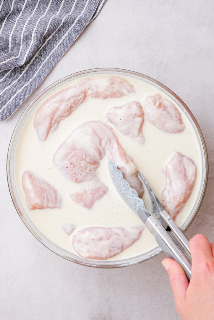 Coating chicken with buttermilk mixture, and refrigerate to make oven fried chicken