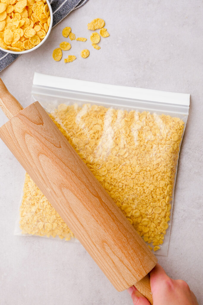 Crushing corn flakes in a ziplock bag