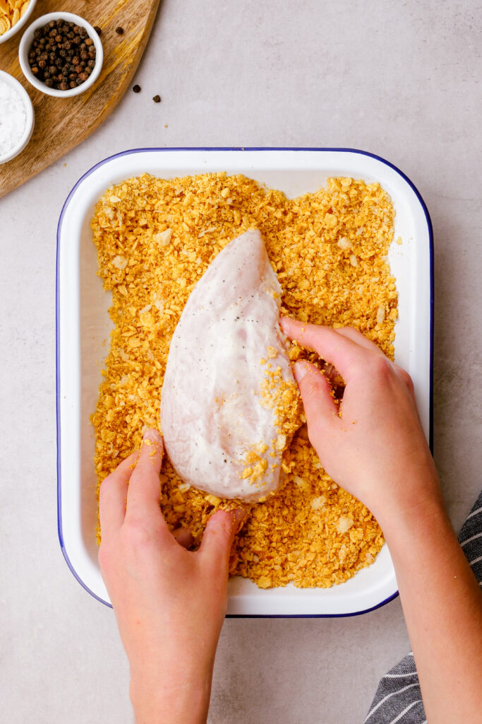 Oven fried chicken, coating the mixture in bread crumbs and corn flakes
